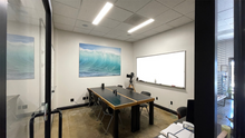 Load image into Gallery viewer, Client Bull Pen and Production Office Rental with Internet, Air Control and Bluetooth Audio, Whiteboards and Glass Doors and Windows.  Inside the heart of Oceanside, California&#39;s brand new Media Arts District.